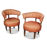 A pair of mid-Victorian tub armchairs, with buttoned curved bar backs, upholstered in a patterned