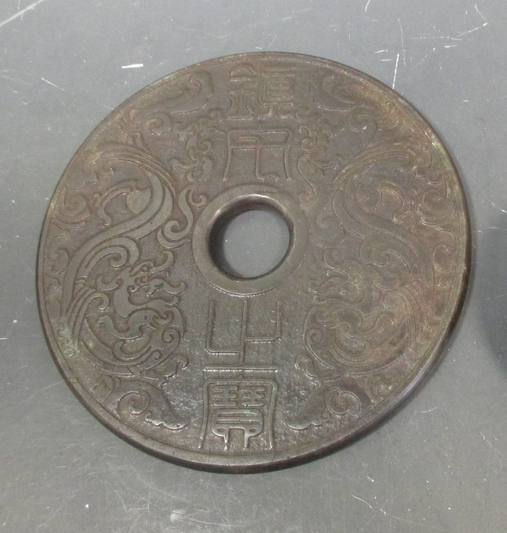 A Chinese lacquered greenstone bi, 15cm diameter