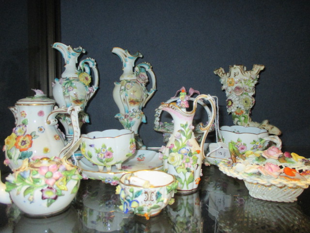 A group of continental floral encrusted porcelain to include two Meissen cups and saucers and a