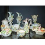 A group of continental floral encrusted porcelain to include two Meissen cups and saucers and a