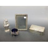 A silver photograph frame, cigarette box, European caster and a salt