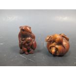 A netsuke, carved as a hare with a leverett, signed; another as two rats with an apple (2)