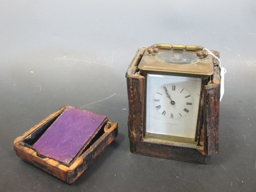 An Edwardian brass carriage clock, striking on a gong, retailer's name, J Bagshaw & Sons Paris, with