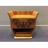 An Art Deco walnut side cabinet, the galleried top above a pair of cupboard doors on U-shaped