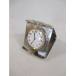 An early 20th century silver cased 8 day travel clock, with Arabic numerals