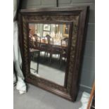 A large rectangular plate wall mirror with incised geometric decoration, 135 x 114cm