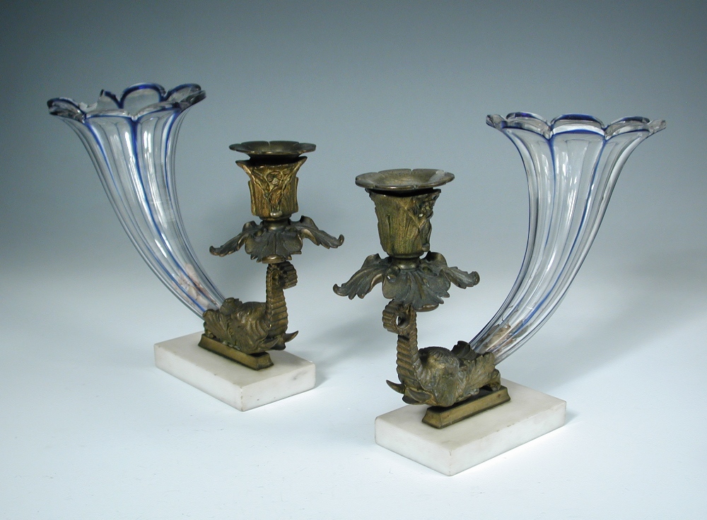 A pair of Regency bronze mounted glass cornucopia, with elephant head terminals, mounted to marble