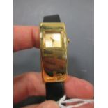 A lady's wristwatch by Jean Louis Scherrer, with rectangular gilt metal face and black faux
