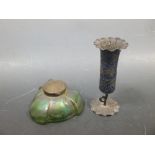 A green iridescent glass inkwell together with an Indian enamelled white metal specimen vase