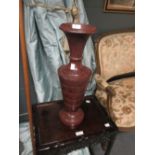 A pair of mottled red stone turned urns, probably early 20th century, 48cm high