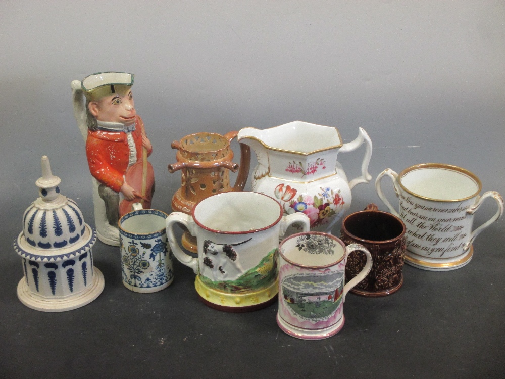 A collection of English pottery to include a puzzle jug frog mugs etc