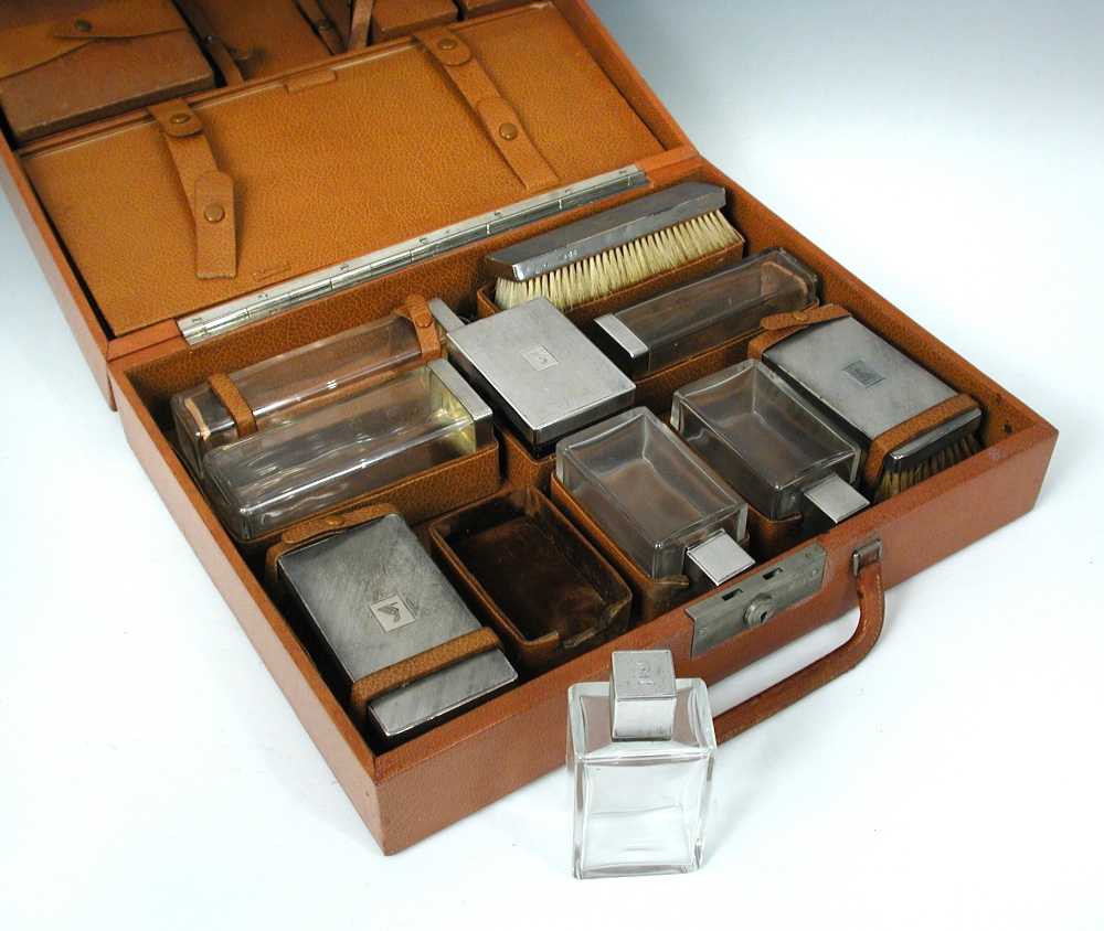 An early 20th century pig skin leather fitted attaché case, the lid fitted with various pigskin