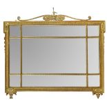 An Edwardian gilt framed overmantle mirror, of neo-classical design, the beaded frame with anthemion