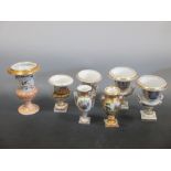 Two pairs of Paris porcelain urns, another urn and two vases