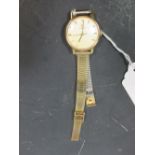 A lady's Omega wristwatch, the round face with champagne coloured dial and baton numerals