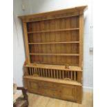 A 19th century pine dresser with chicken coup base 215 x 166 x 45cm