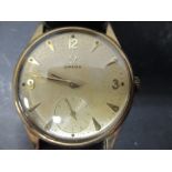 A gentlemans Omega wristwatch, the unmarked yellow metal round dial with buff coloured face and