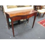 A George III mahogany serpentine shape foldover card table