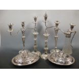 A pair of twin branch three light candelabra on the vaseknopped columns, together with a pair of