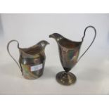 A helmet shaped early 19th century silver cream jug and another with engraved decoration, 7oz