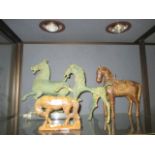 A Persian style wooden model of a horse, a Tang style model of a horse on perspex base and a