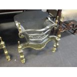 A George III style metal and brass fire grate