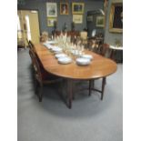 A Georgian style mahogany oval dining table with seven leaf extension (with leaf carrier), approx