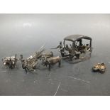 Two Indian silver miniature buffalo drawn carts and a pair of shoes