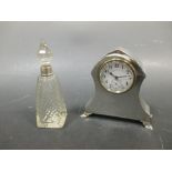 A silver mounted dressing table clock and a scent bottle