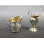 A George III style silver cream jug and another pedestal cream jug, 8oz, (2)