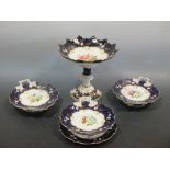 A 19th century Staffordshire dessert service, painted to the centre with flowers within blue