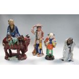 Two pottery figures of Daoist immortals and two Guangdong figures, the taller of the first with