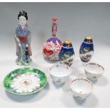 A Kutani lady, Imari bottle vase, pair of casters, three tea bowls and a Canton saucer, the