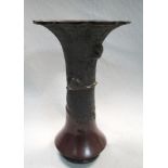 A late 19th/early 20th century bronze vase, the flaring petal edged rim above two cranes in relief