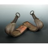 A pair of 17th/18th century stirrups, the crest curved toes running down from buckle attachments