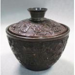 A 19th century pewter lined coconut bowl and cover, the wood carved in relief with precious