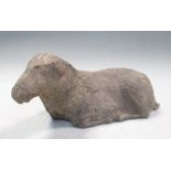 A Han dynasty grey pottery reclining horse, the animal with its head slightly turned to its left,