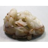 A white jade group of three goats, the stone with brown inclusions pierced and carved as three goats