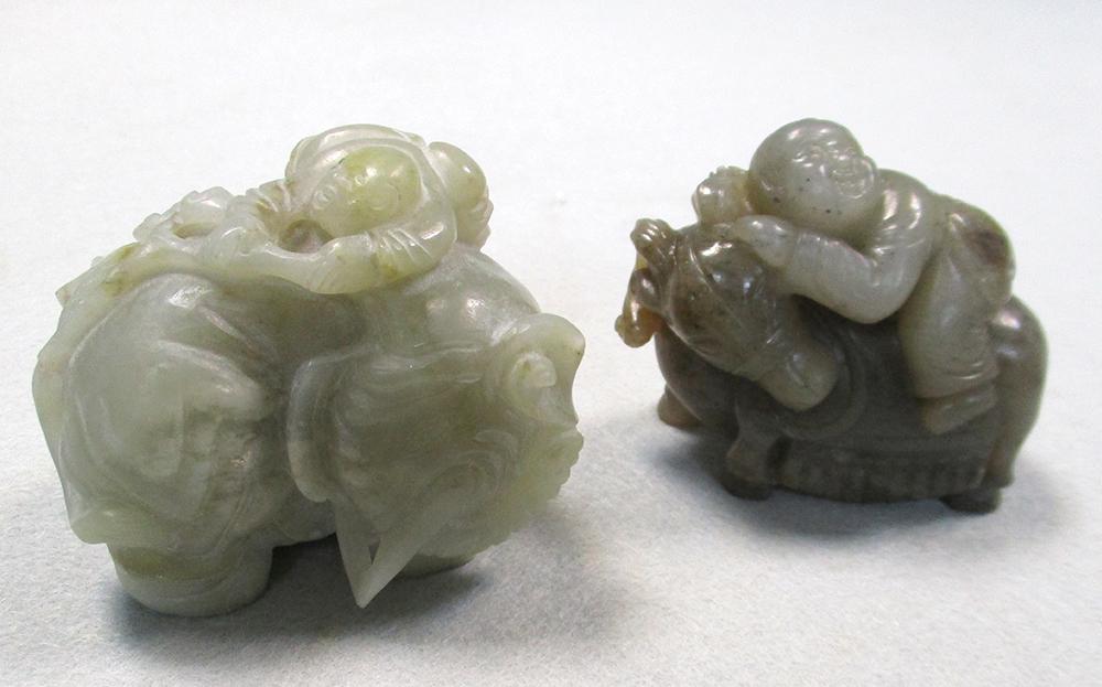 Two jade groups of children riding an elephant and a deer, the first of smokey grey stone, the child