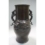 A late 19th/early 20th century bronze vase, the swollen cylindrical shape applied with dragon