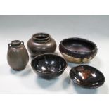 Three treacle glazed bowls and two vases, mainly Song or Yuan dynasties, the smallest bowl impressed