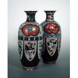 A pair of early 20th century cloisonne vases, the waisted green ground necks enamelled with