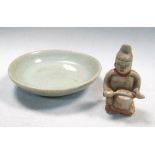 A Sawankhalok celadon figure and a celadon small dish, the seated figure playing a drum, 7.5cm (3