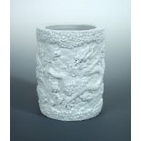 Wang Bingrong', a white glazed brush pot, the cylindrical exterior moulded in a relief with blue