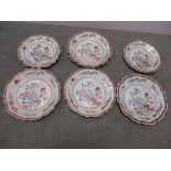 A graduated set of six 18th century famille rose dishes, gilt scrolling on the iron red wavy rim