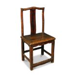 A 19th century pine chair, the serpentine top rail above a shaped vertical strap splat, solid