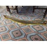 A Regency style serpentine shaped brass and cast iron fire grate