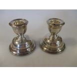 A pair of miniature plain silver dressing table candlesticks by WJ Myatt and Co, Birmingham, 1923,