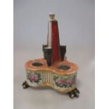 An early 19th century English porcelain inkwell, the three wells arranged around a central