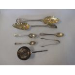 Two Georgian silver berry spoons, four silver tea spoons, a pair of silver sugar tongs, and a